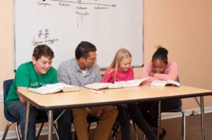 Christian High School Students Smiling with Teacher